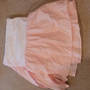 Light pink bed skirt for crib